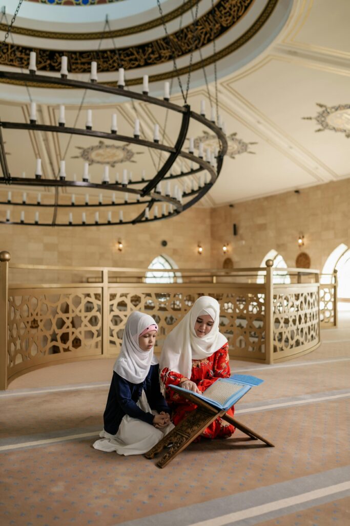 mom teaching daughter from a book