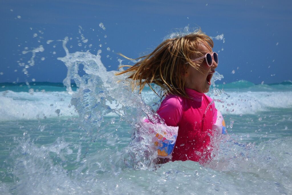 girl playing in the waves