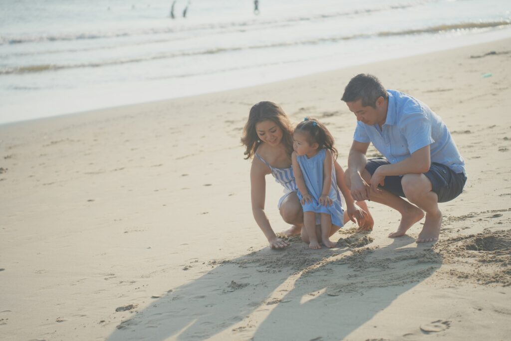 Mom, dad and child enjoying day on the beach