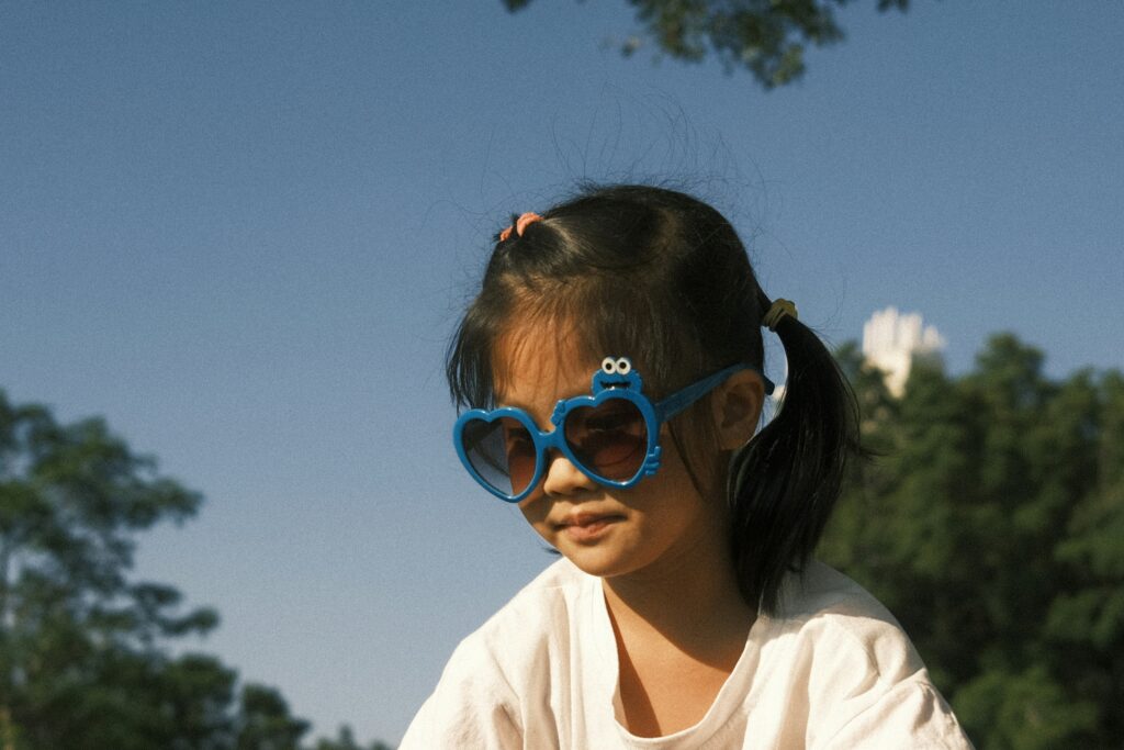girl wearing blue sunglasses and white t shirt