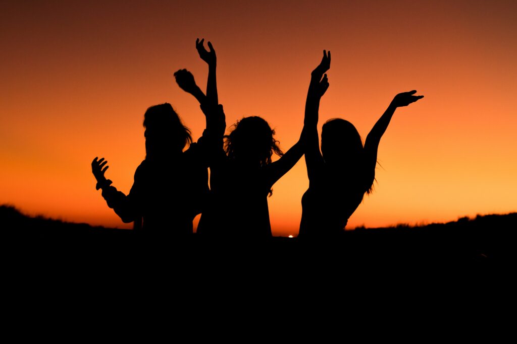 silhouette of three women having fun