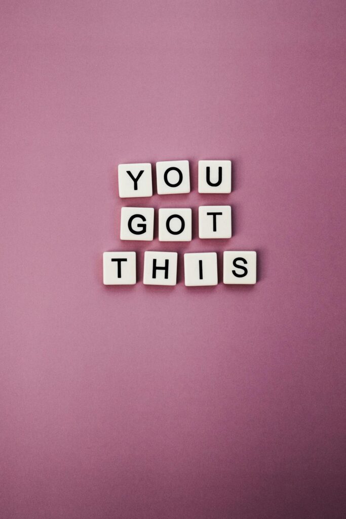 tiles spell out "You Got This" in pink background, encouraging presence over perfectionism in motherhood