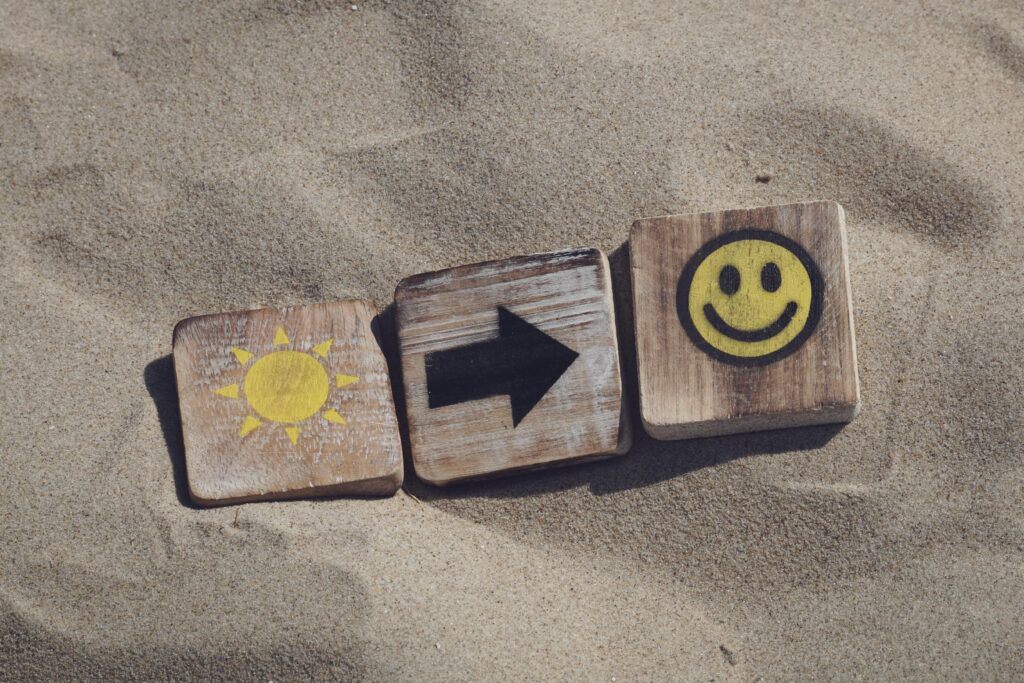 three brown tiles in the sand