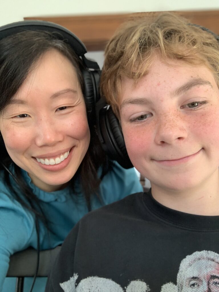 Aunt and nephew with headphones on, recording a podcast
