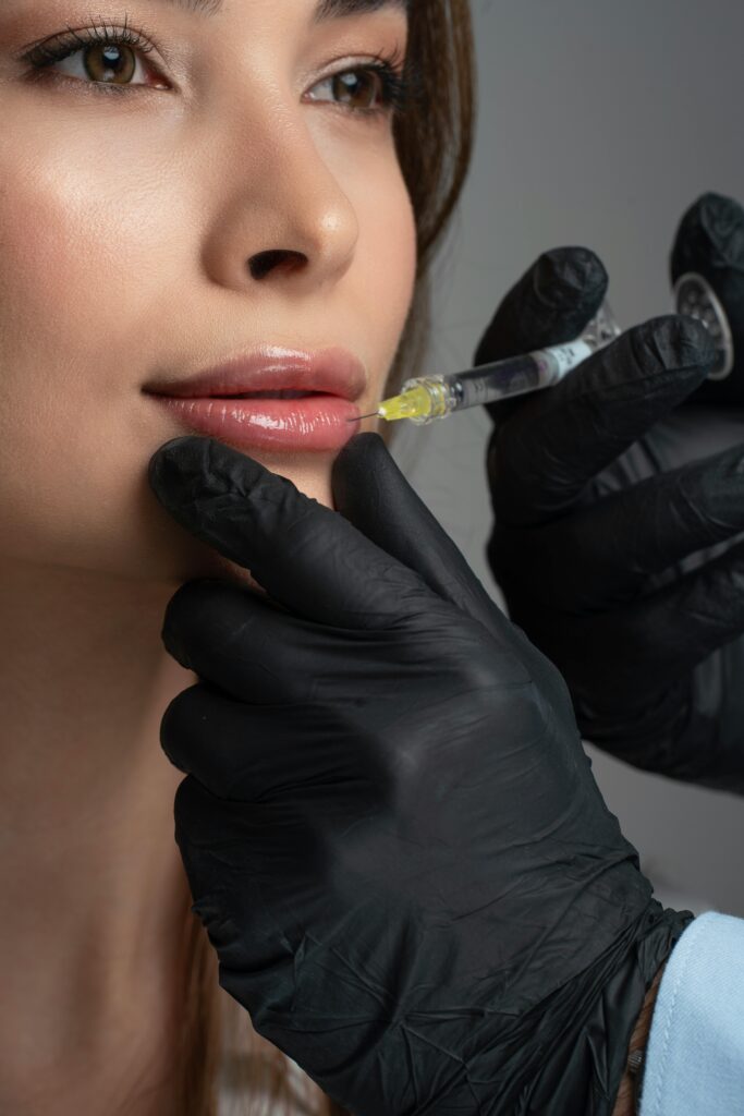 woman getting an filler injection in her lips